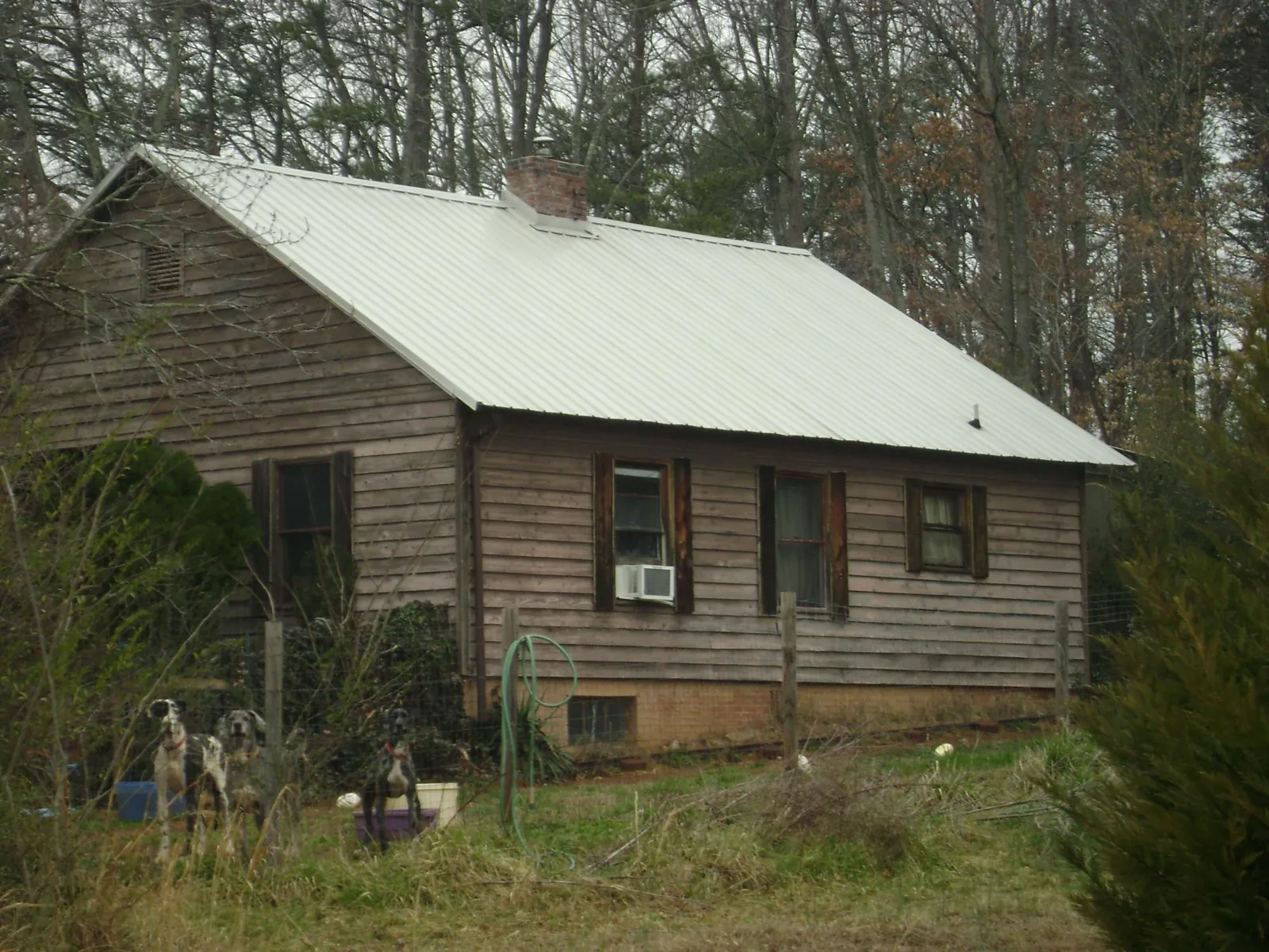 White metal roof on an old wood sided farmhouse, from a Asphalt Shingle Roof Repair job in Justice